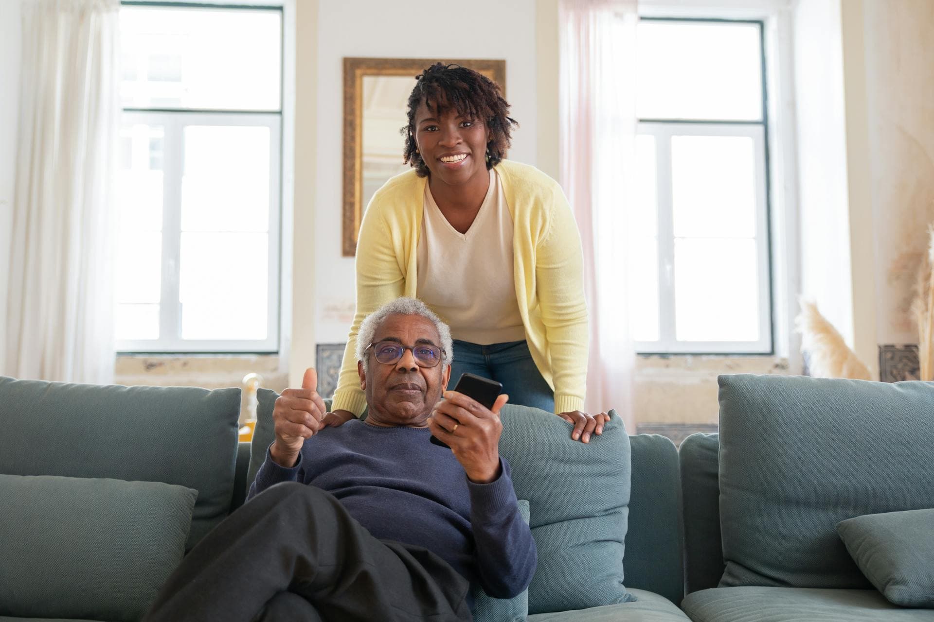 A Megacare caregiver sharing a joyful moment with a member at home